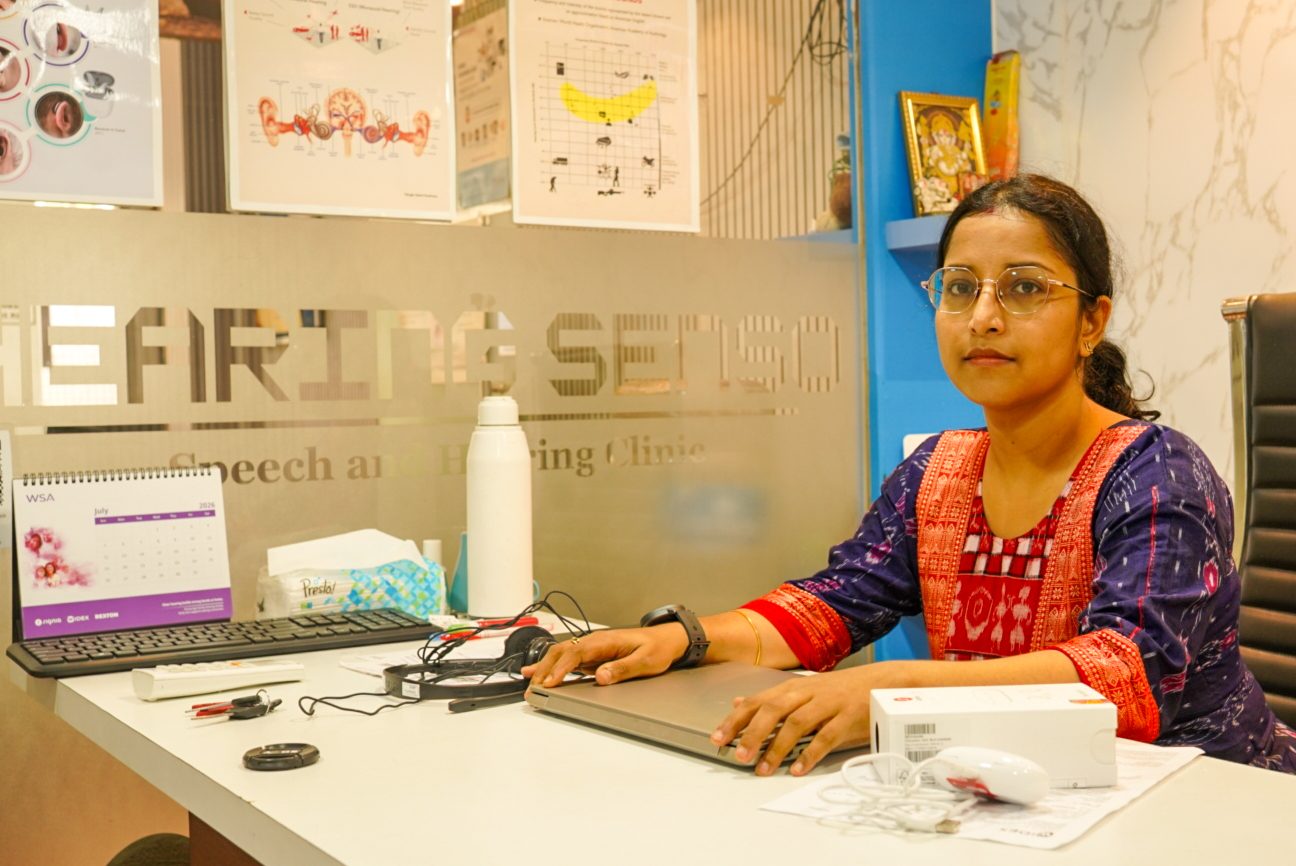 Audiologist reviewing a patient's details at the consultation desk